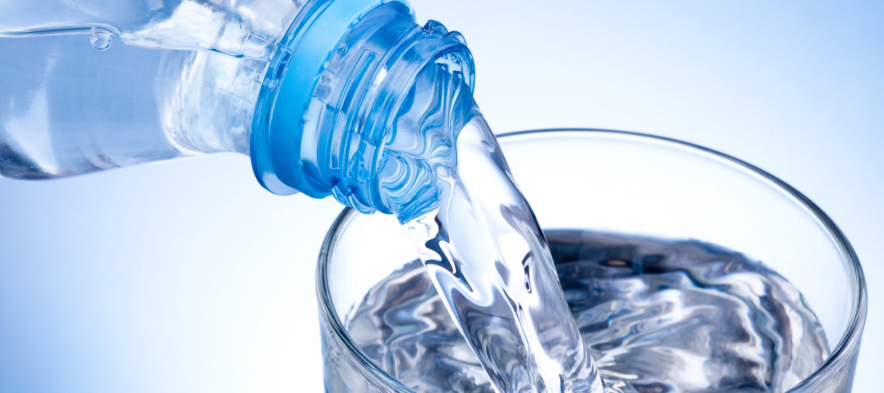 Vapor distilled water being poured into a glass