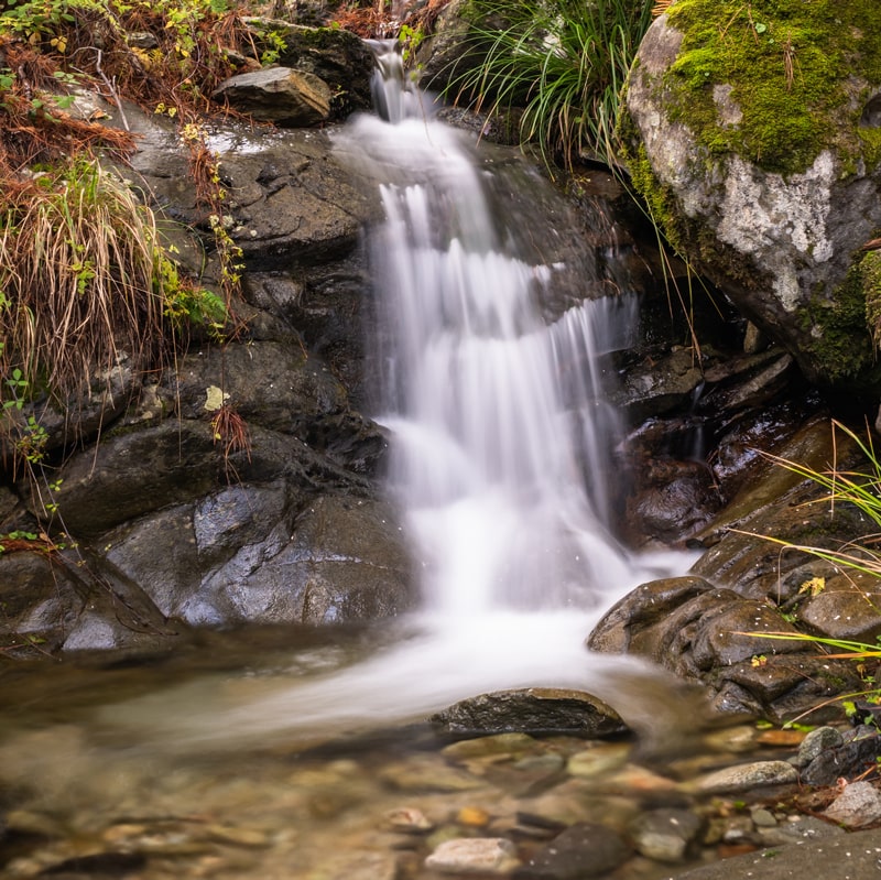 Spring water flowing down rocks in a stream