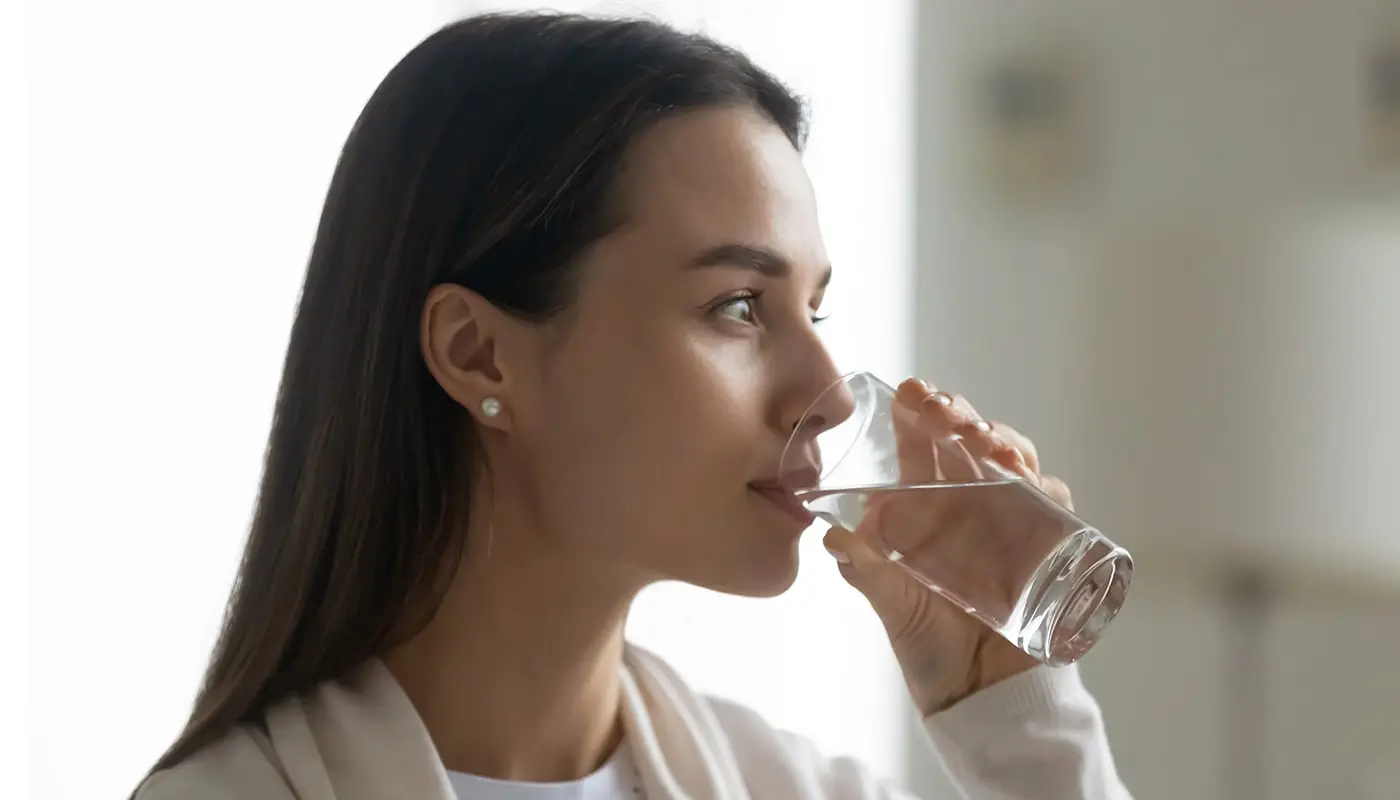 A woman drinking fluoride-free water.