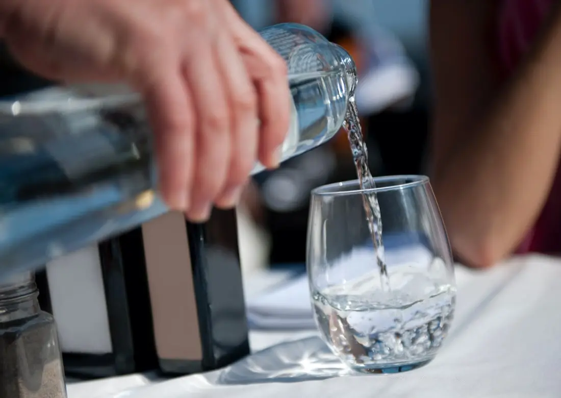 distilled water being poured in a glass